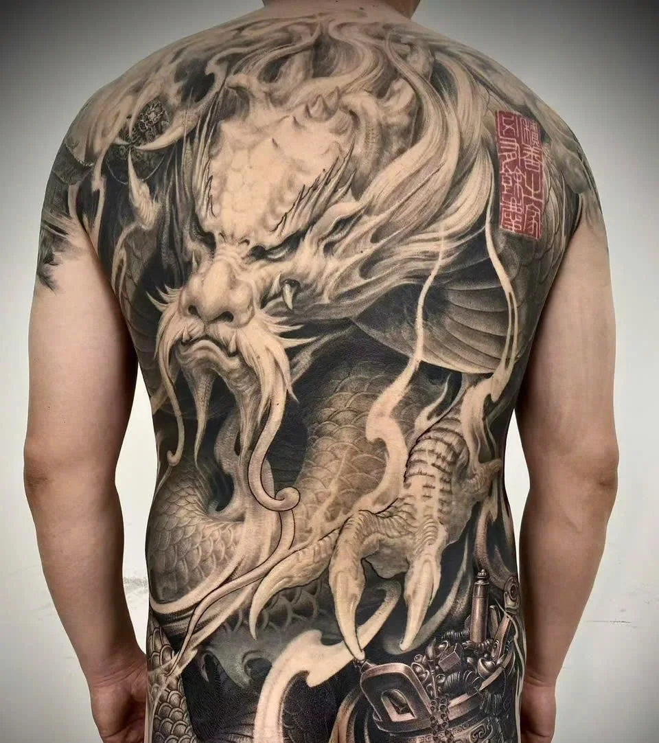 A freehand black-and-grey dragon back piece by Yue Heng.